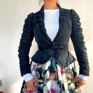 Fitted, belted  jacket with one big snap button on both jacket and belt.